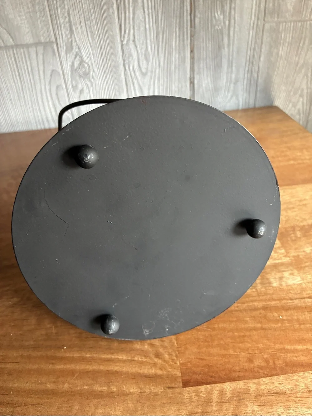 Decorative black metal hurricane lantern/candle lantern. It has a clear glass